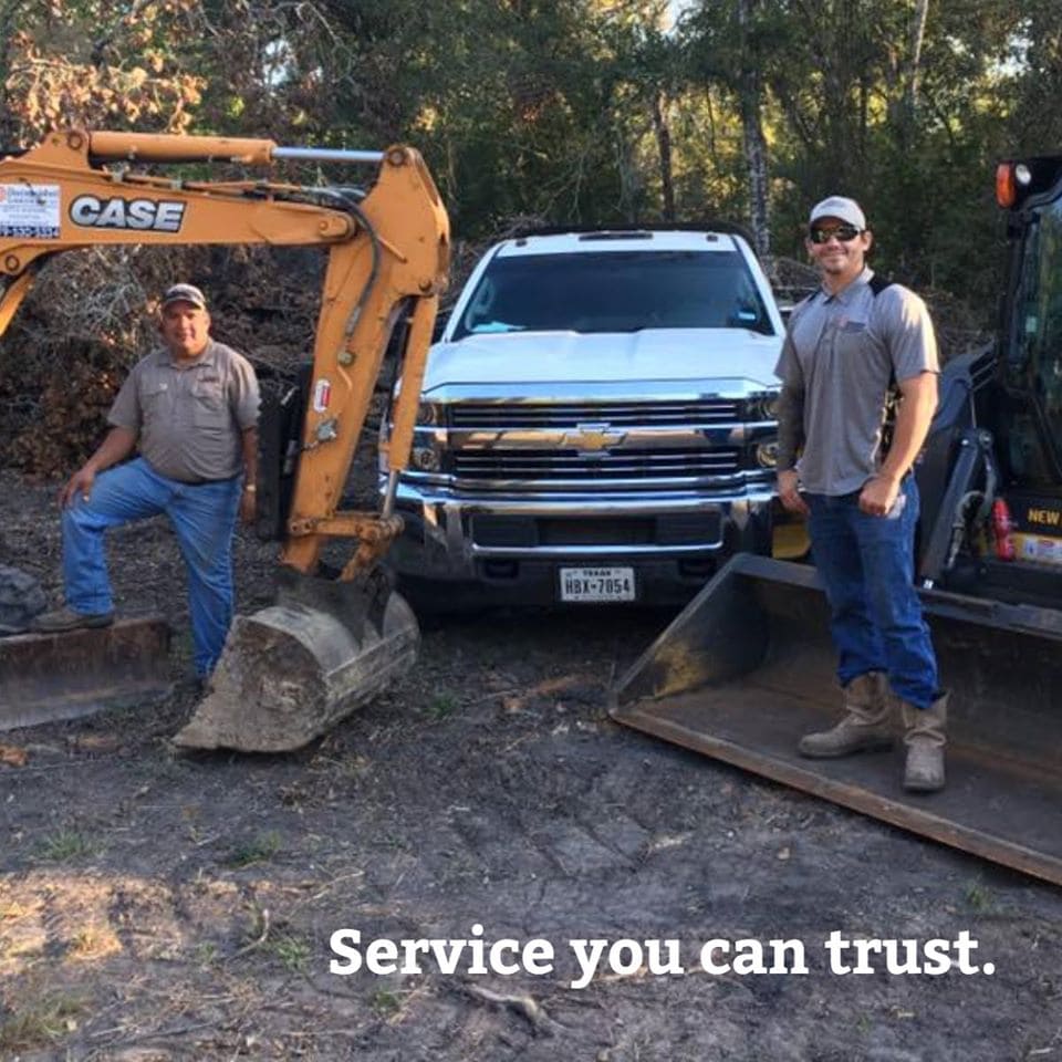 Two men in front of truck with equipment